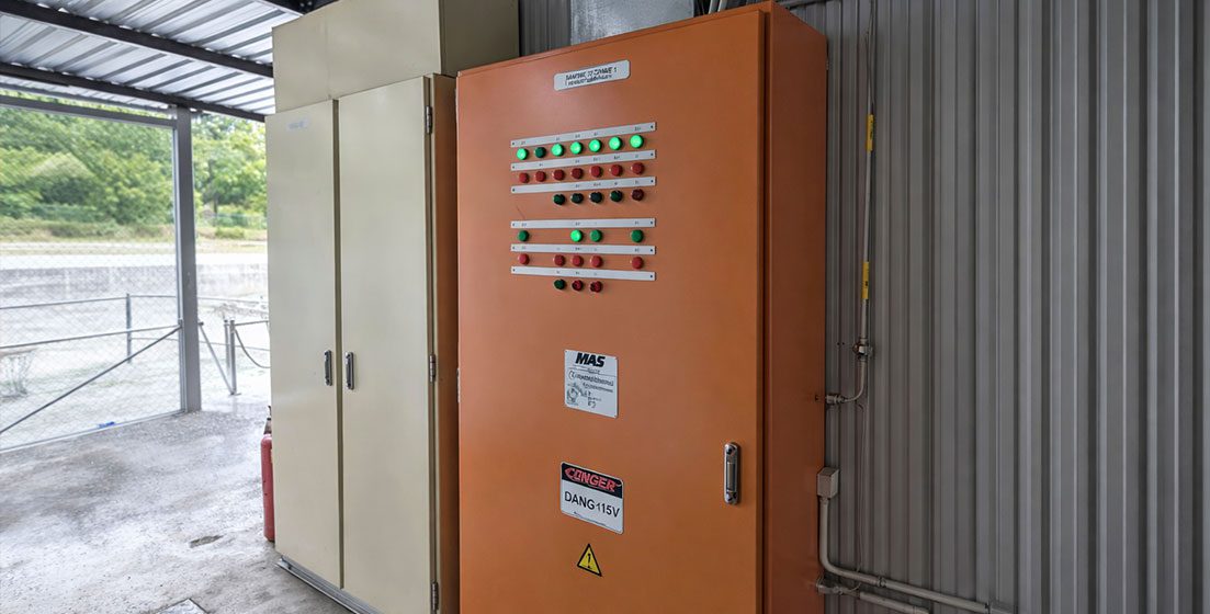 An orange electrical panel in a building, showcasing MAPs Control and Automation services