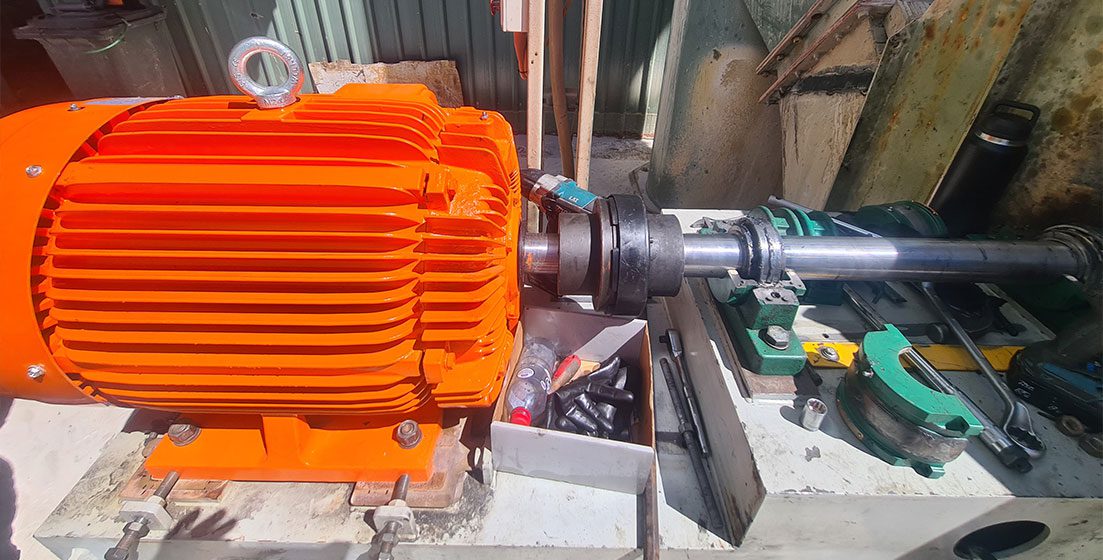 An orange electric motor displayed on a table, representing MAPs HVAC Service & Maintenance